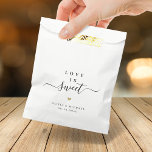 Love is sweet simple elegant script wedding favour bags<br><div class="desc">Modern minimalist script "love is sweet" with colour editable heart shape and couple's names and event date,  simple and elegant. Great favour bags for modern wedding or other events. 
See all the matching pieces in collection.</div>