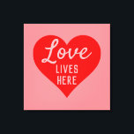Love Lives Here Message Canvas Print<br><div class="desc">An upbeat message that says "Love Lives Here". Red and Pink colour theme with a large heart as the main motif. Sign for a happy home.</div>