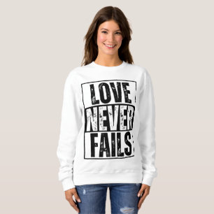 LOVE NEVER FAILS SWEATSHIRT