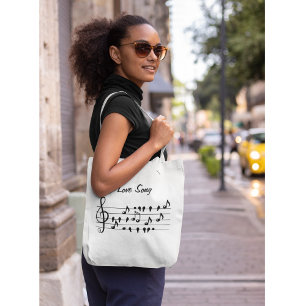 Love song, birds sitting in between musical notes tote bag
