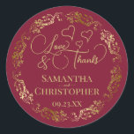 Love & Thanks Elegant Burgundy & Gold Wedding Classic Round Sticker<br><div class="desc">These beautiful burgundy and gold stickers are designed to use as wedding favour tags, or as envelope seals for your wedding thank you cards. The elegant design features an ornate lacy golden border with fancy script lettering reading "Love & Thanks!" There are romantic hearts scattered about with room for the...</div>