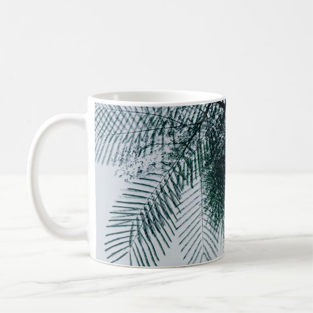 Low-angle photo of green tree coffee mug (Left)