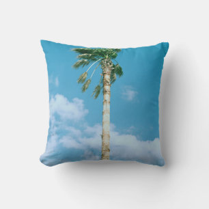 Low-angle photo of palm trees under blue sky cushion