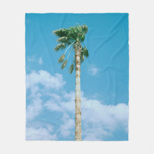Low-angle photo of palm trees under blue sky fleece blanket