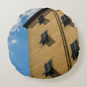 LOW ANGLE PHOTOGRAPHY OF BROWN LOUVER WINDOW ROUND CUSHION