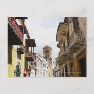 Low angle view of apartments along the street postcard