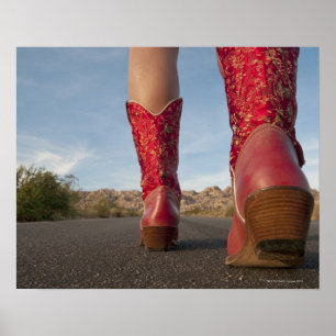 Low-angle view of woman wearing cowboy boots poster