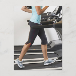 Low section of woman walking on treadmill postcard