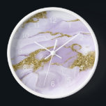 Lux Ink Lavender Abstract ID990 Clock<br><div class="desc">This flowing,  alcohol ink abstract design sets the perfect tone for a modern apartment or home office. In shades from soft lavender to lilac purple with glittering gold accents,  the wall clock design is shown here framed in white. Search ID990 to see other products with this eye-catching design.</div>
