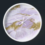 Lux Ink Lavender Abstract ID990 Clock<br><div class="desc">This flowing,  alcohol ink abstract design sets the perfect tone for a modern apartment or home office. In shades from soft lavender to lilac purple with glittering gold accents,  the wall clock design is shown here framed in white. Search ID990 to see other products with this eye-catching design.</div>