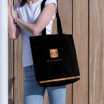 Luxury elegant gold modern black monogrammed tote bag<br><div class="desc">Classy exclusive looking office or personal monogrammed tote bag featuring a faux copper metallic gold glitter square with your monogram name initials and a sparkling stripe over a stylish black faux leather look background. Suitable for small business, corporate or independant business professionals, personal branding or stylists specialists, makeup artists or...</div>
