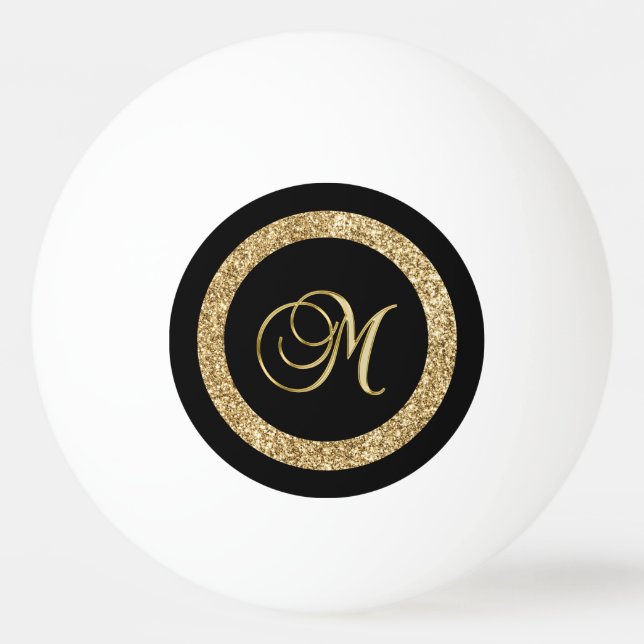 M gold monogram on black ping pong ball (Front)