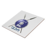 Maccabee Shield And Spears Tile<br><div class="desc">A depiction of a Maccabee's shield and two spears. The shield is adorned by a lion and text reading "Yisrael" (Israel) in the Paleo-Hebrew alphabet. "Maccabee" also appears in modern Hebrew. The Maccabees were Jewish rebels who freed Judea from the yoke of the Seleucid Empire. Chanukkah is not just a...</div>