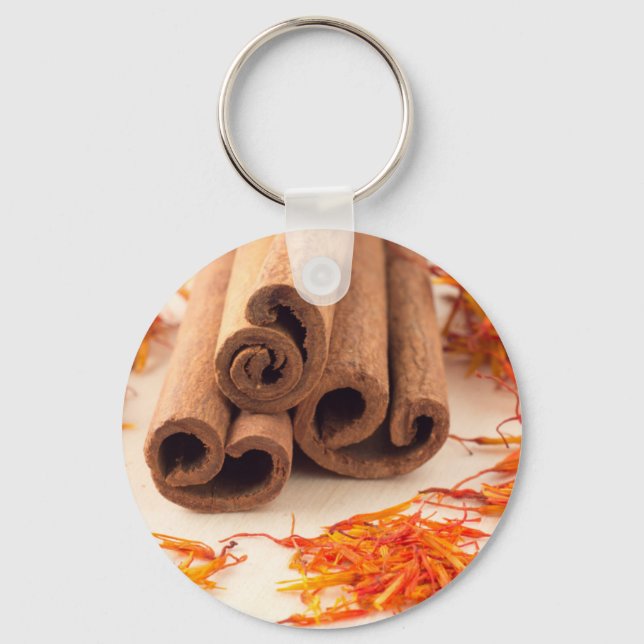 Macro view of the sticks of cinnamon and saffron key ring (Front)