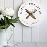 Made With Love In Nana's Kitchen Whisk Bakery Large Clock<br><div class="desc">Simple, clean, and minimal style bakery clock design featuring "made with love in Nana's Kitchen. Faux natural woodgrain bakers rolling pin and whisk design are crossing each other and placed in the centre of the clock. Customise with monogram initials. Perfect gift for your nana or grandma. All artwork by Moodthology....</div>