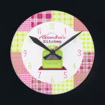 Madras Plaid Kitchen Clock<br><div class="desc">A clock featuring an illustration of a green stove at centre.  Background is madras inspired plaid pattern. Numerals are pink and green.  Personalise with your name.</div>