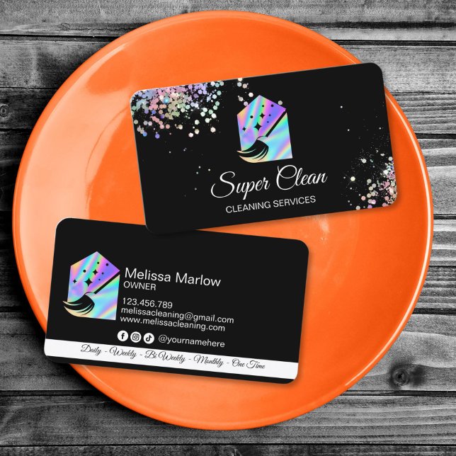 Maid Cleaning House Holographic Sparkling Business Business Card (holographic cleaning logo with a house and a broom, glitter details, black background business card)