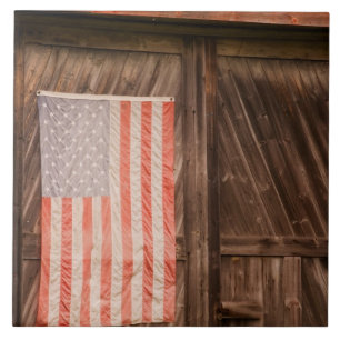 Maine, Faded American flag on door of old barn Tile