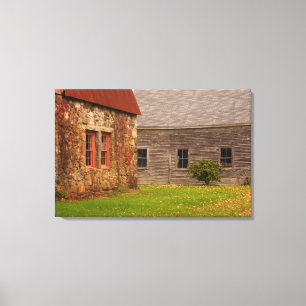 Maine, Old stone building and wooden barn in Canvas Print