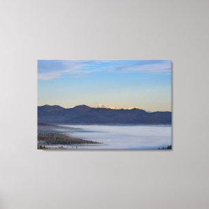 Majestic mountain Triglav with fog in valley Canvas Print