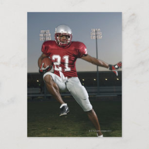 Male football player carrying football postcard
