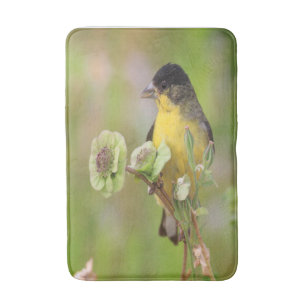 Male Goldfinch perched on flowers Bath Mat