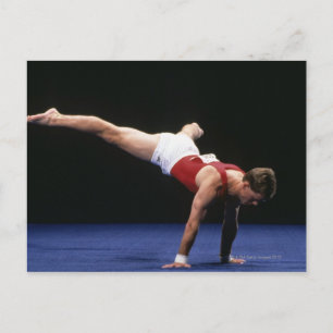 Male gymnast peforming a routine in the floor postcard