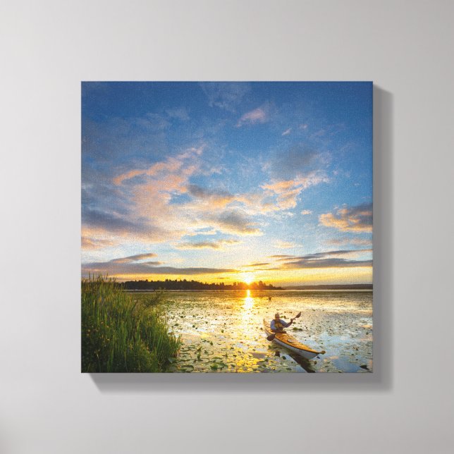 Male kayaker paddling sea kayak on still water canvas print (Front)