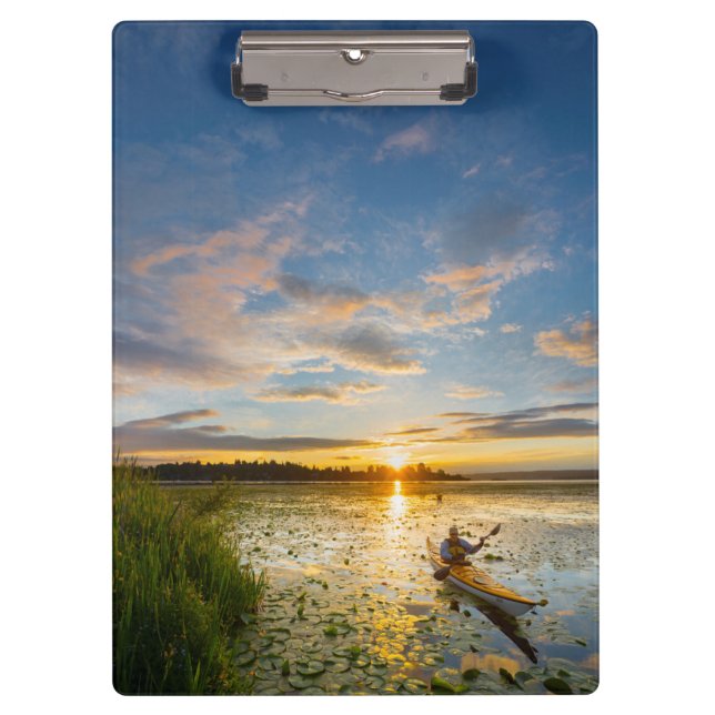 Male kayaker paddling sea kayak on still water clipboard (Front)