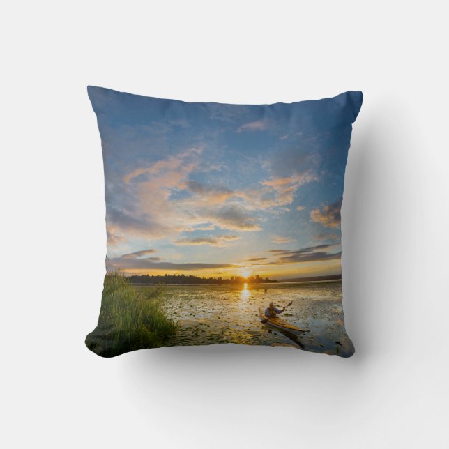 Male kayaker paddling sea kayak on still water cushion (Front)