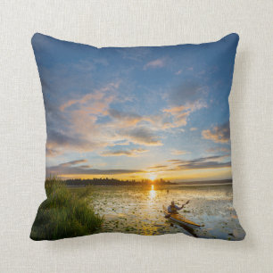 Male kayaker paddling sea kayak on still water cushion