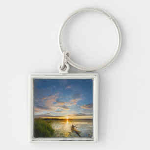 Male kayaker paddling sea kayak on still water key ring