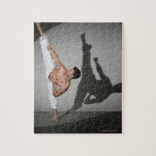 Male martial artist performing kick, studio shot jigsaw puzzle