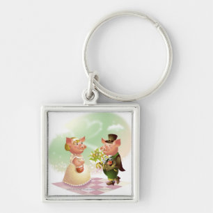 Male pig gives a bouqet of flowers to a female pig key ring