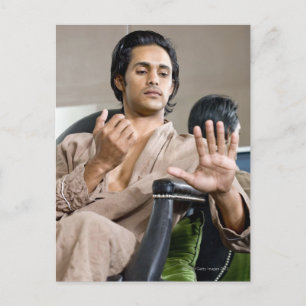 Man admiring his manicure postcard