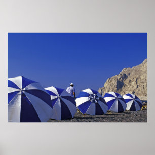 Man and Beach Umbrellas, Santorini (Greece) Poster