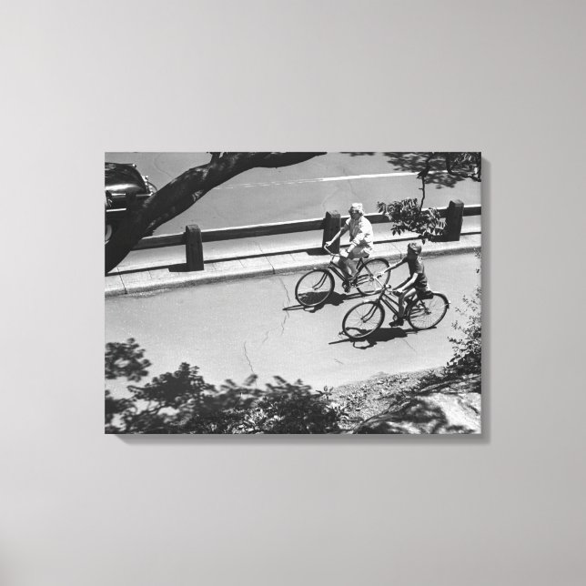 Man and Boy Cycling Canvas Print (Front)