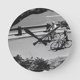 Man and Boy Cycling Round Clock