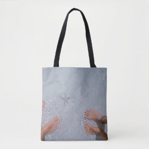 Man and woman on seashore nearby starfish tote bag