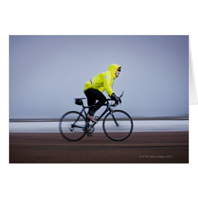 Man bicycles on a cold and foggy winter day. (Front Horizontal)