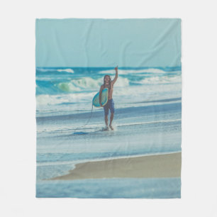 Man carrying surfboard at beach fleece blanket