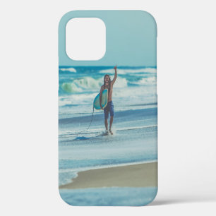 Man carrying surfboard at beach iPhone 12 case