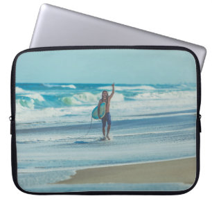 Man carrying surfboard at beach laptop sleeve