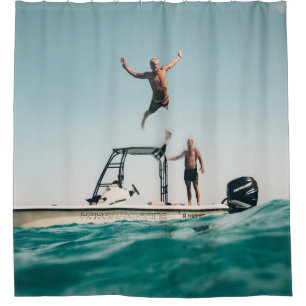 Man diving on pool shower curtain