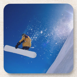 Man flying through the air on a snowboard with coaster