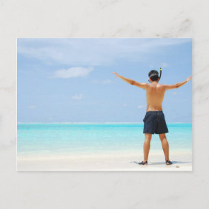 man getting ready to go snorkelling in a tropical  postcard