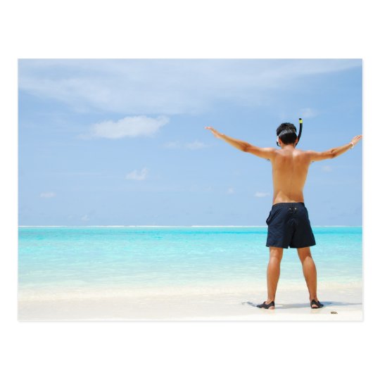 man getting ready to go snorkelling in a tropical postcard