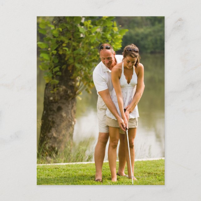 Man helping woman golf postcard (Front)