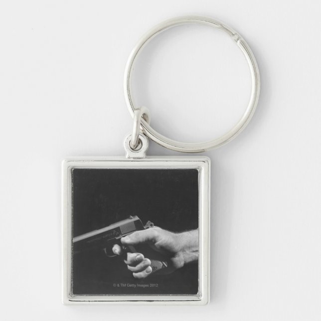 Man Holding Gun Key Ring (Front)