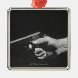 Man Holding Gun Metal Tree Decoration